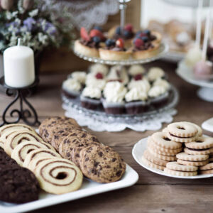 table-with-various-cookies-tarts-cakes-cupcakedvs-an-PARM8L9.jpg
